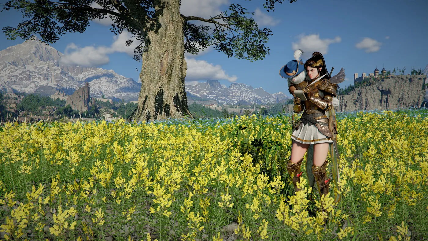 A dark-haired swordswoman in bronze and gold armour with a white pleated skirt and a winged shoulder piece stands in a field of yellow flowers, holding a quill and a notebook, with a white cat in a blue feathered musketeer hat perched on her shoulder, a large tree and snowy mountains behind her, in Crimson Desert.