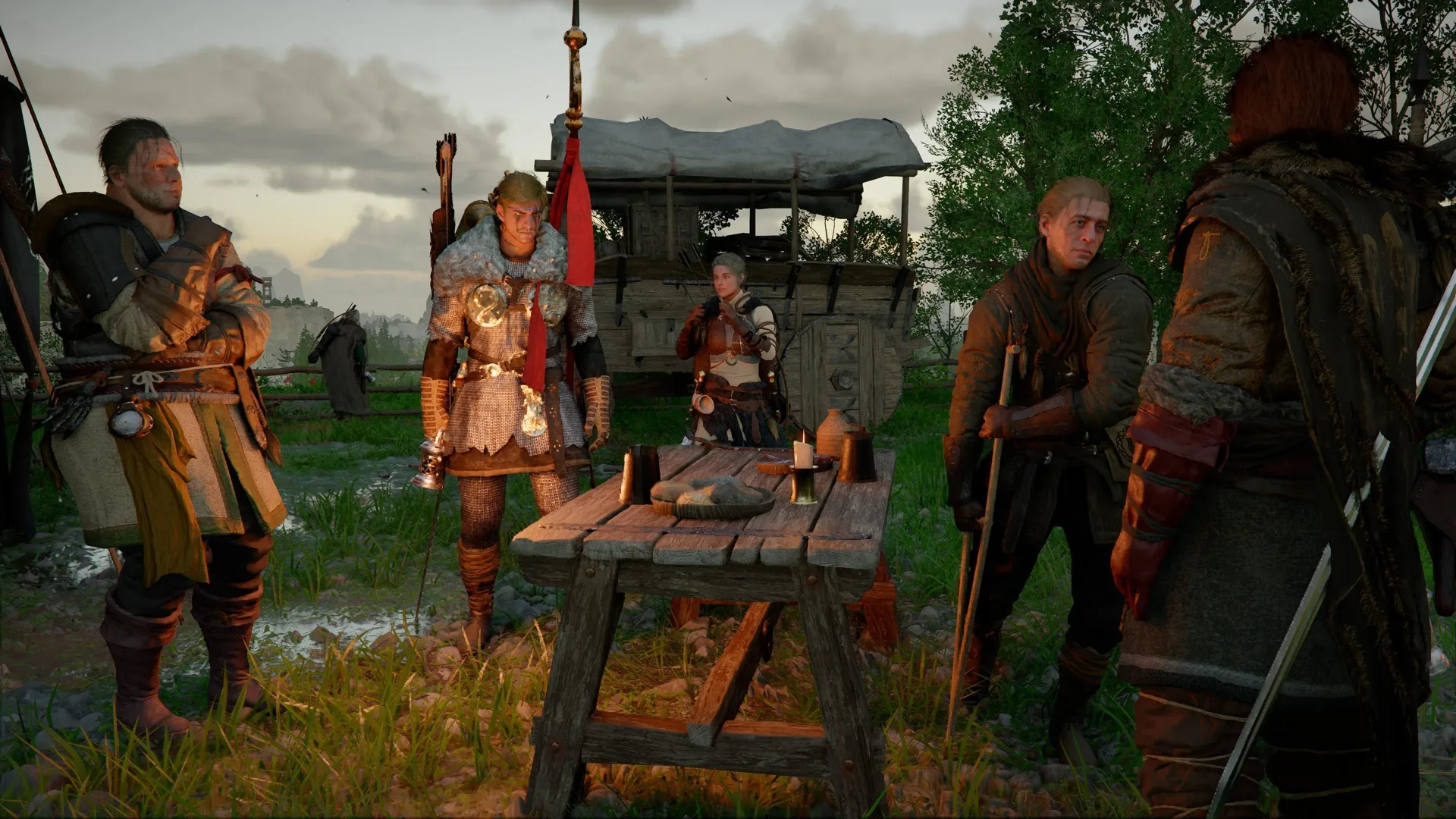 Greymane comrades gathered around a wooden table at the Howling Hill camp in Crimson Desert, with a covered supply wagon behind them.