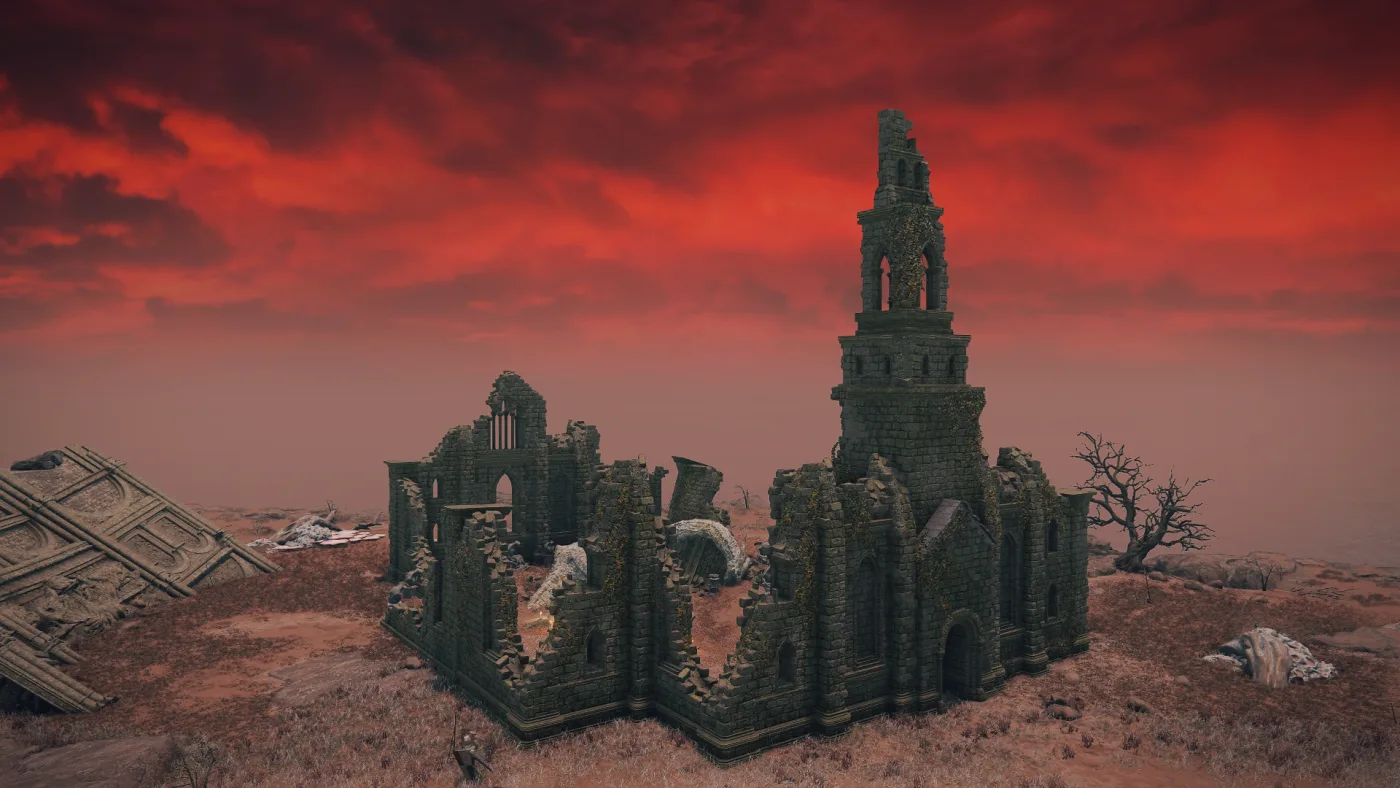 The Cathedral of Dragon Communion in Elden Ring: a ruined, moss-covered stone cathedral with a tall broken bell tower, standing on dry red-brown ground in Caelid under a blood-red sky.