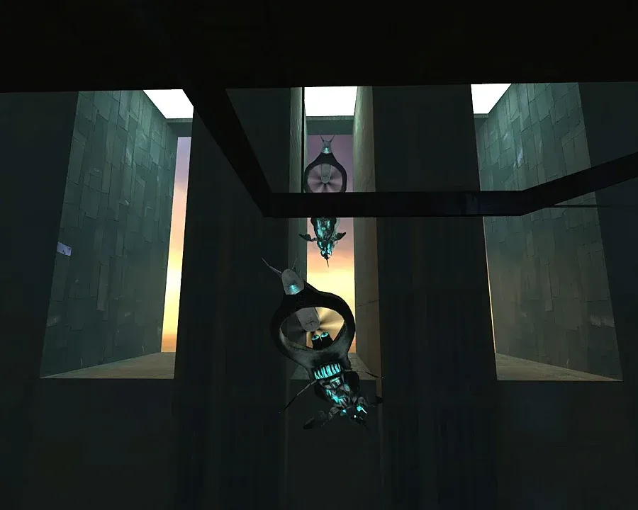 The interior of the Combine Citadel in Half-Life 2: a tall atrium with slatted grey walls and skylights glowing orange with sunset, two Manhacks hanging motionless from the ceiling.