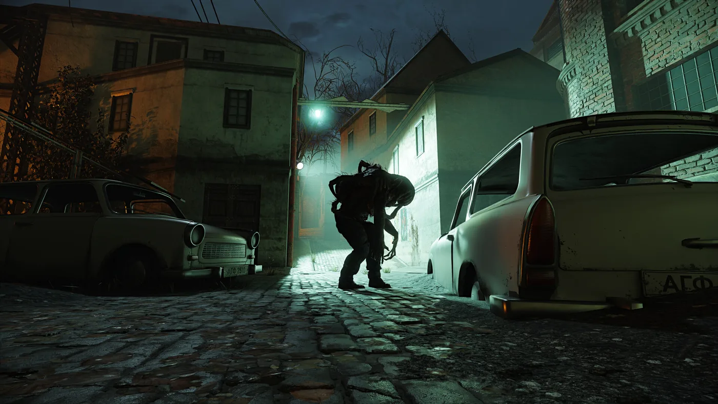A Steam store screenshot from the Half-Life 2 RTX demo's Ravenholm section, which predates Update #4: a low view down a cobbled street at night, a hunched zombie silhouetted between two parked cars against the glare of a pale green street lamp, with old houses and bare trees behind.