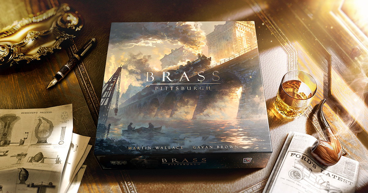 Product art for Brass: Pittsburgh by Roxley Games — the box sitting on a wooden desk beside a whisky glass, a smoking pipe, a fountain pen and Bessemer process engineering diagrams, its cover showing a steam locomotive crossing a stone bridge over a smoke-filled river city, credited to Martin Wallace and Gavan Brown.