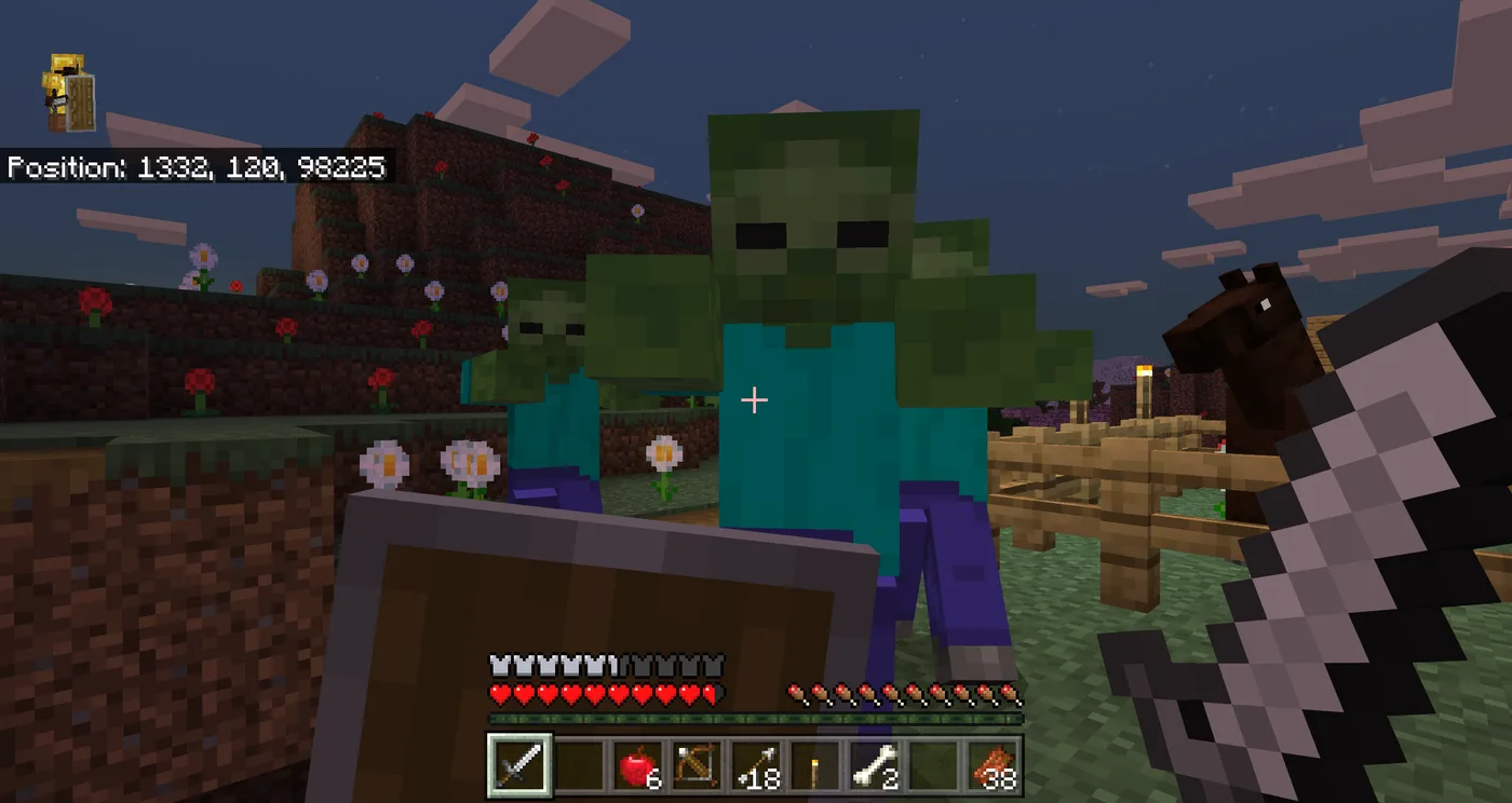 First-person view of a Minecraft player holding up a shield against two zombies at night, health and hunger bars visible on the HUD.