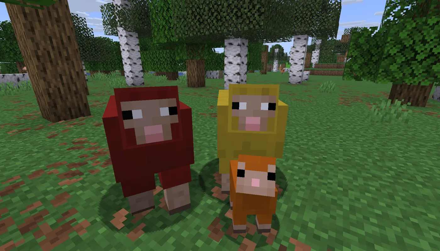 A red Minecraft sheep and a yellow Minecraft sheep standing side by side in a birch forest with a small orange lamb between them.