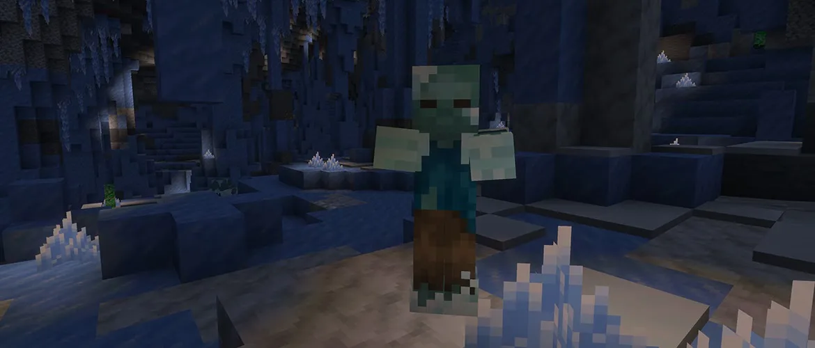 A frostbite, a pale blue-green zombie in a teal shirt and torn brown trousers, walking toward the camera through a dark Minecraft ice cave with ice crystals on the floor and icicles on the ceiling behind it.
