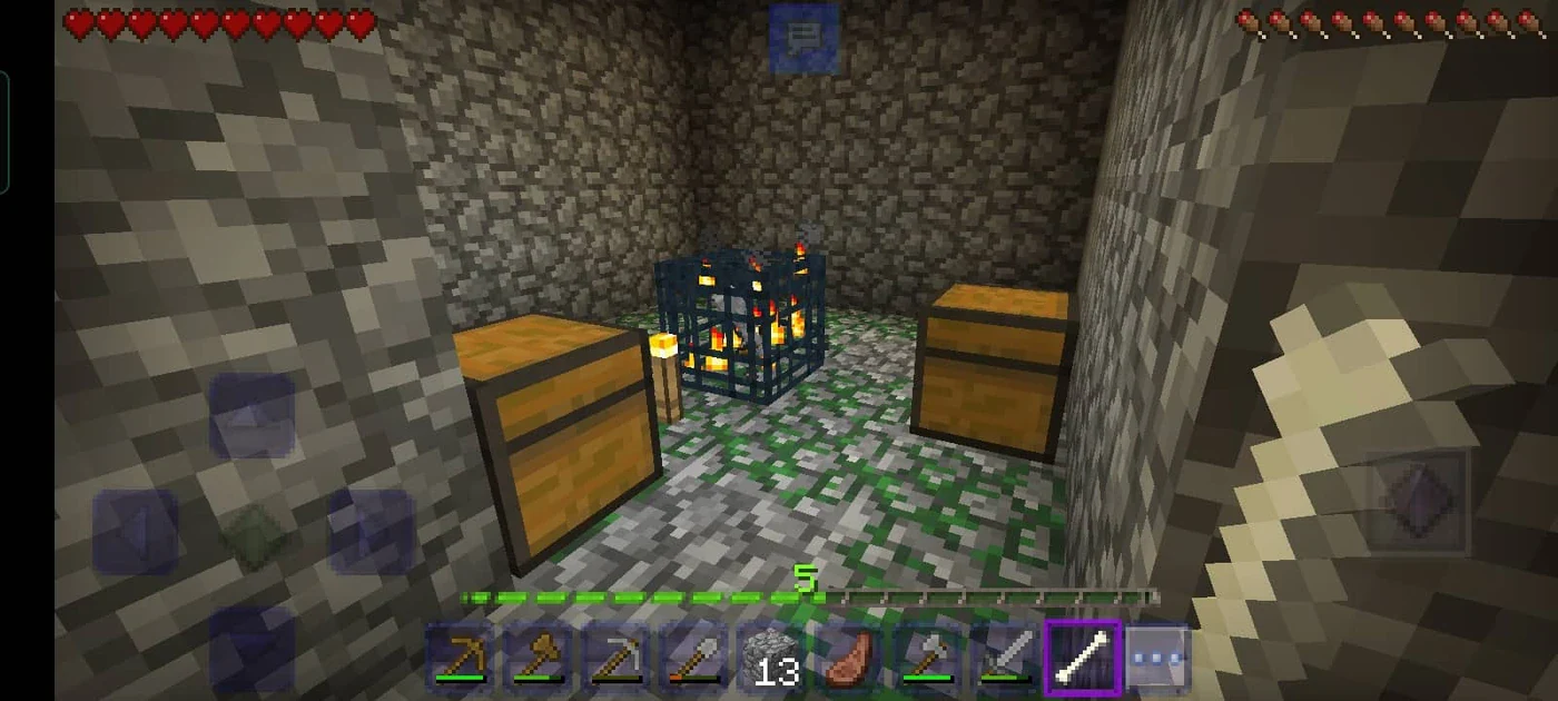 A Minecraft monster spawner block glowing in a dark dungeon, with the miniature mob model spinning inside its iron cage.