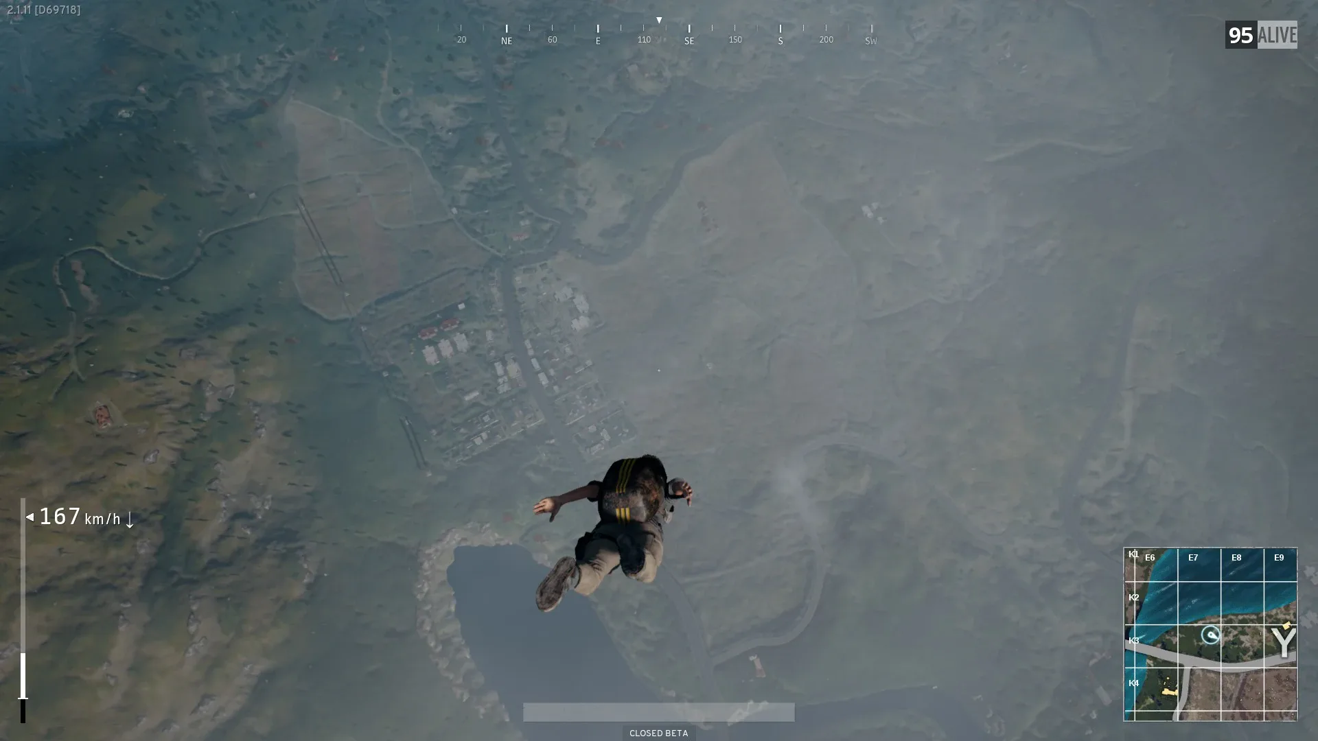 A PUBG player descending under a parachute toward the drop zone — the early game starts in the air, not on the ground.