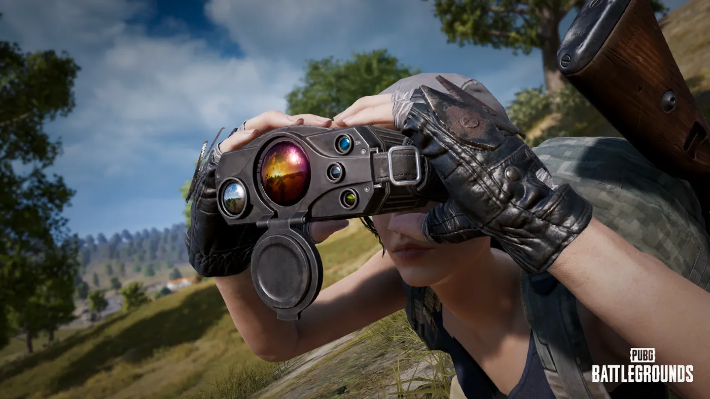 A prone PUBG player glassing the terrain through the Spotter Scope binoculars, rifle slung on their back.