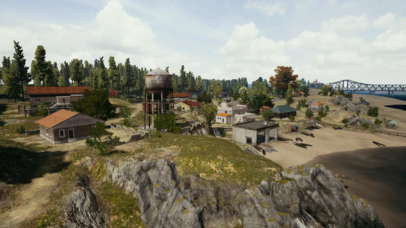 The Ferry Pier village on Erangel with its water tower — shared landmarks like this let a squad anchor callouts everyone understands instantly.