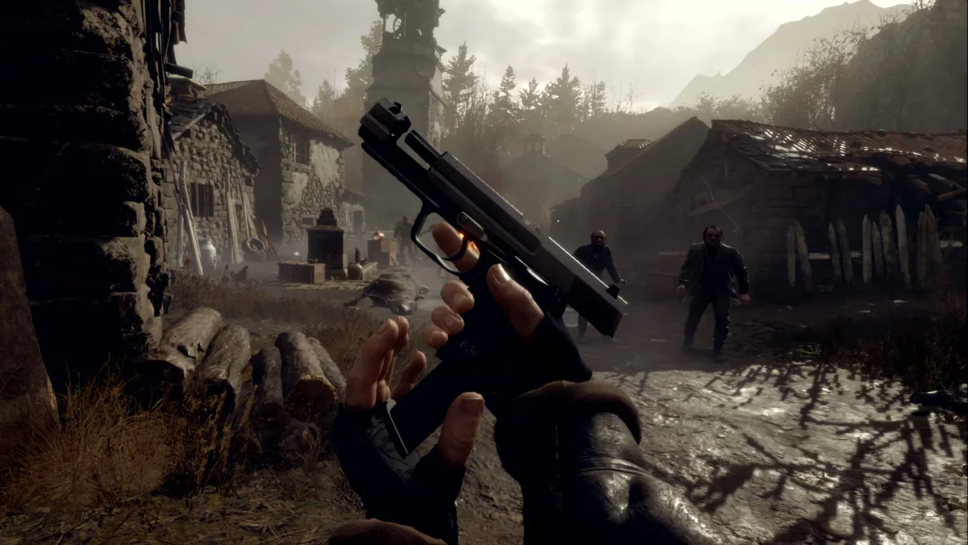 First-person view in Resident Evil 4 VR Mode with a handgun held in both hands as two villagers approach across the village, the church tower visible behind them.
