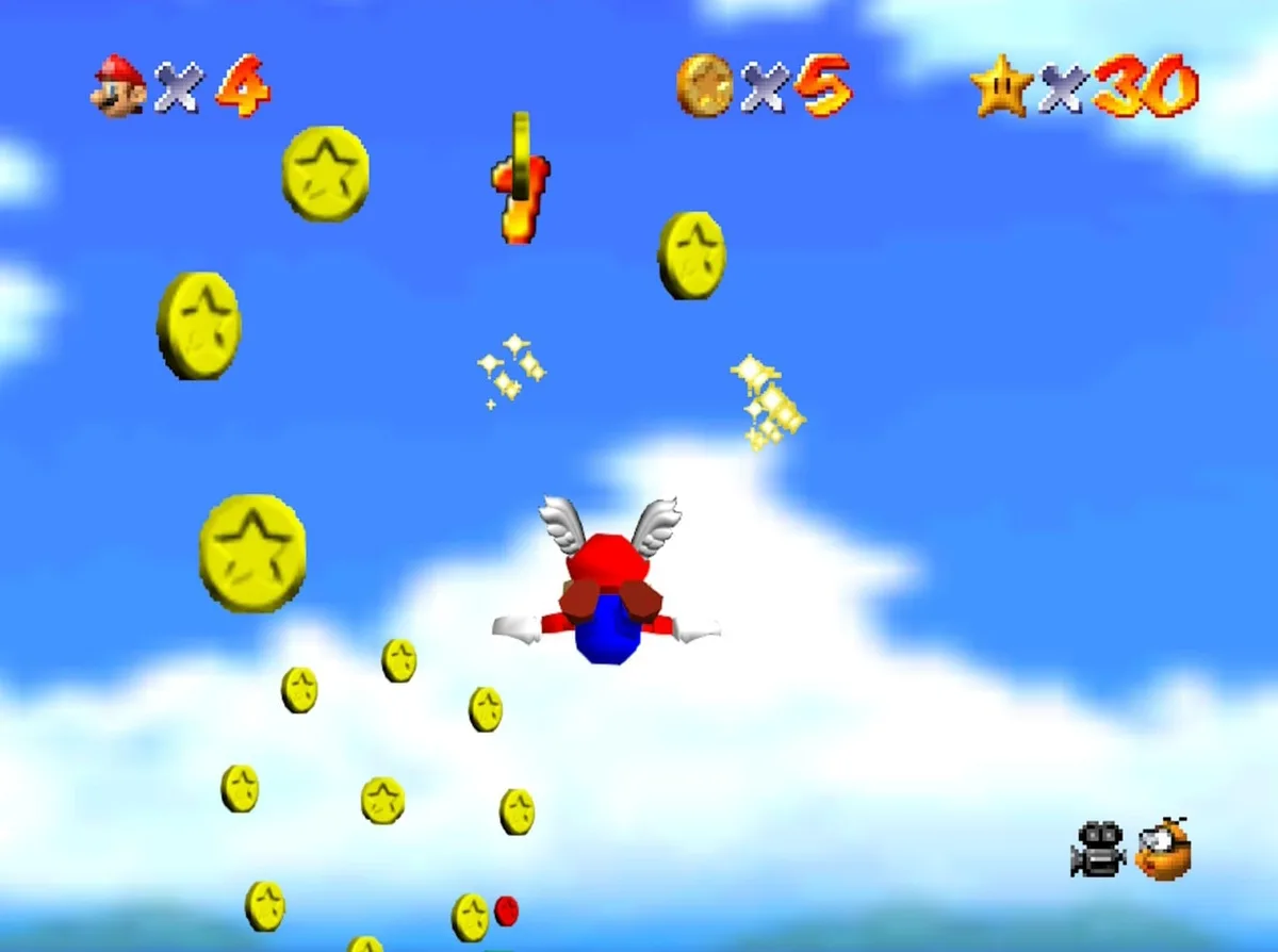 Wing Mario gliding through a trail of spinning yellow coins high above Bob-omb Battlefield, with the coin counter reading five.