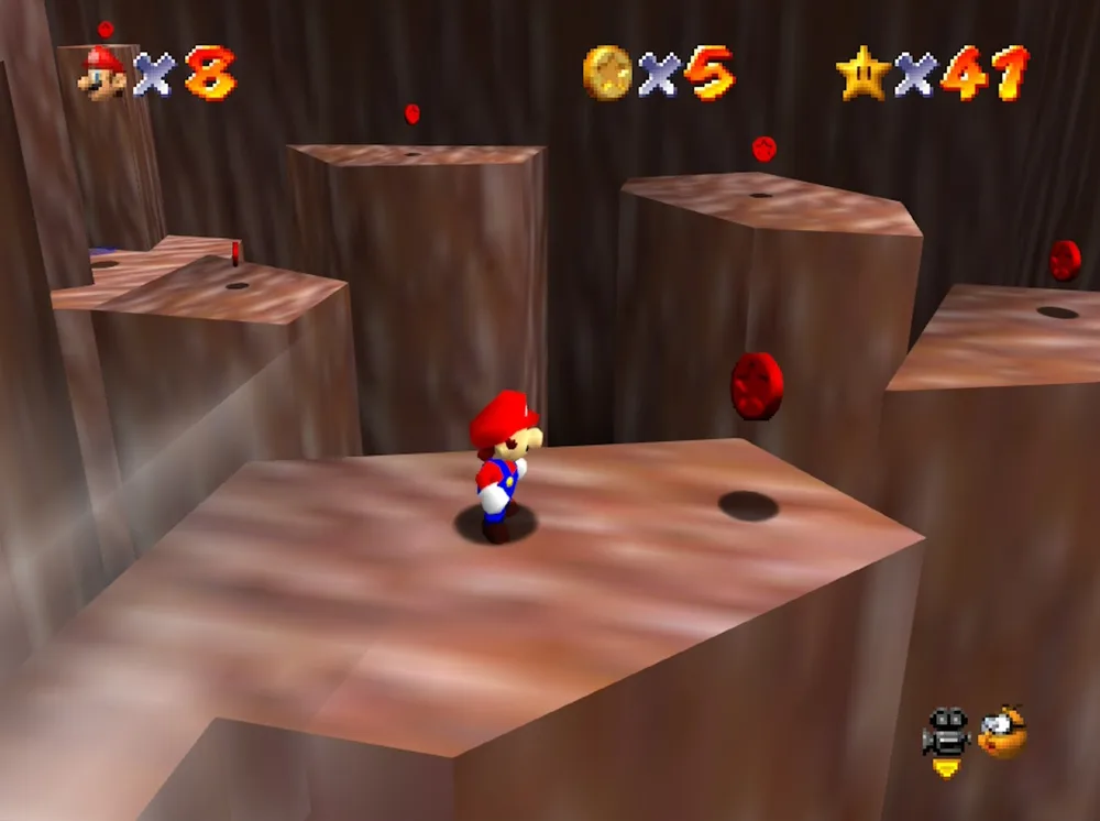 Mario in Wiggler's underground cave in Tiny-Huge Island, surrounded by floating red coins above tall rock pillars.
