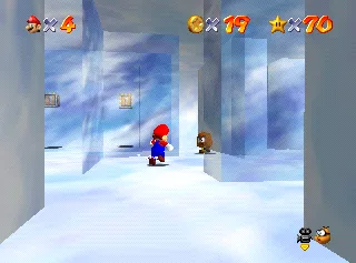 The entrance to the igloo in Snowman's Land in Super Mario 64, reached by crawling through a low opening.