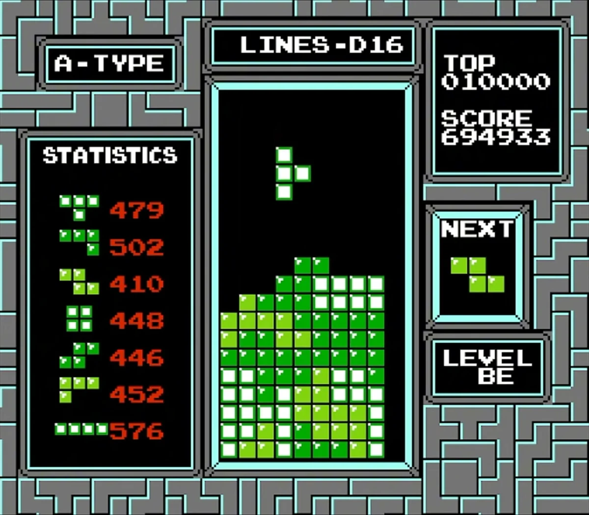NES Tetris A-Type gameplay with the statistics panel showing per-piece counts of T 479, J 502, Z 410, O 448, S 446, L 452 and I 576, a Z piece in the Next box, and a score of 694,933.