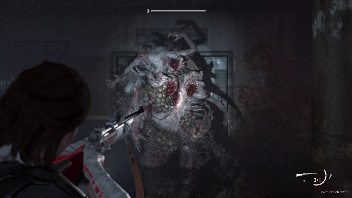 Ellie aiming a hunting rifle at the Rat King, a fused mass of Infected, with a boss health bar across the top of the screen.