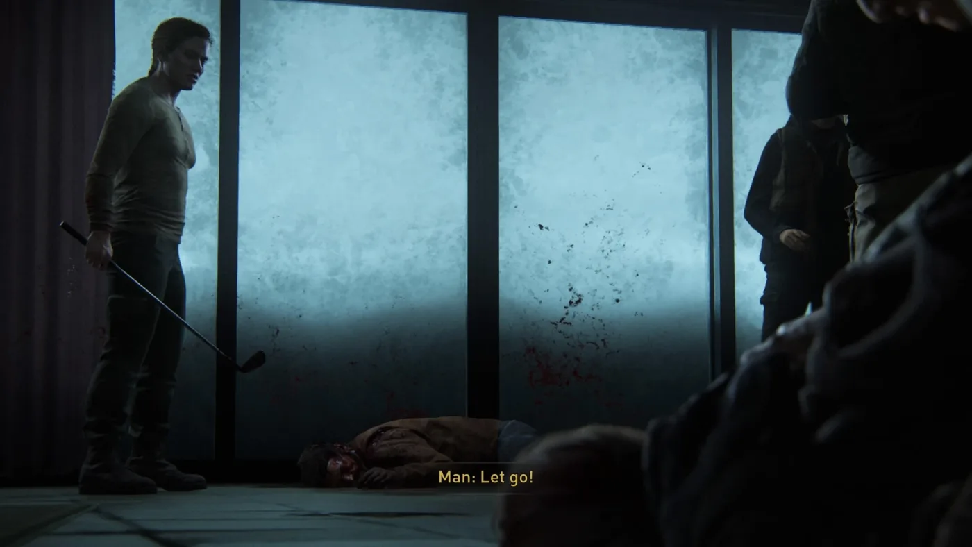 Abby standing over a near-death Joel in the Baldwin lodge basement in The Last of Us Part II, making sure Ellie watches.