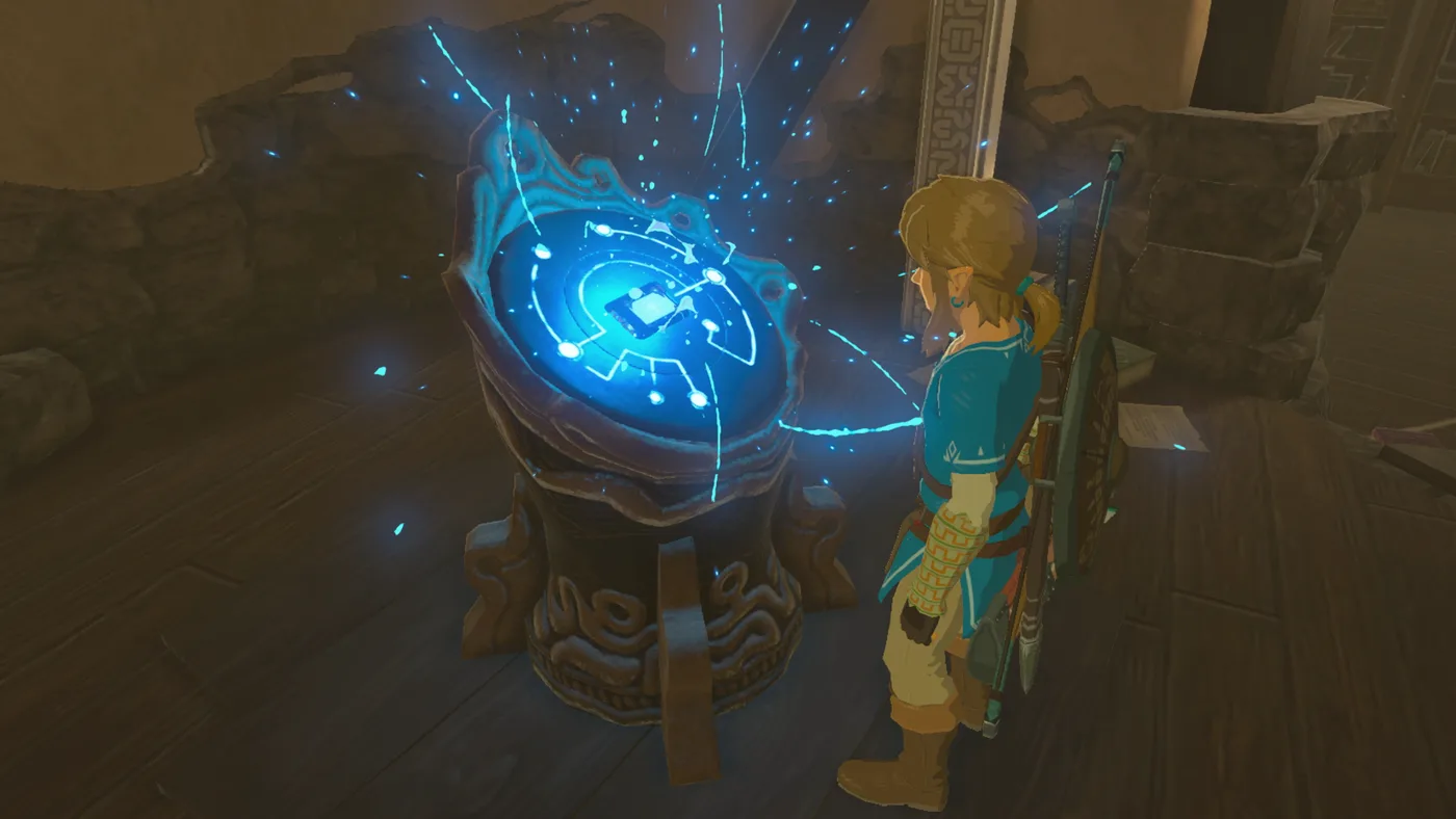 Link at the Guidance Stone inside the Hateno Ancient Tech Lab in Breath of the Wild, the Sheikah Slate docked and glowing blue as a rune is powered up during Slated for Upgrades.