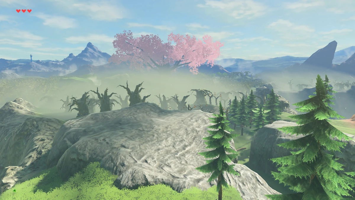 The Lost Woods seen from above in Breath of the Wild, a field of gnarled dead trees smothered in white fog with a pink blossom tree rising out of it.