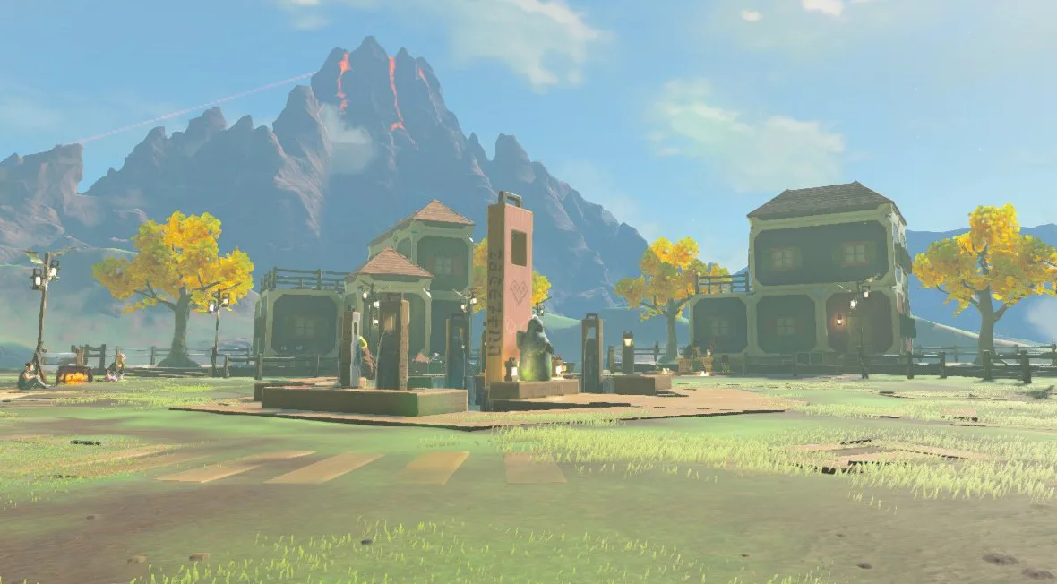 An overview of the finished Tarrey Town in Breath of the Wild, showing the ring of colorful Bolson Construction houses around the central fountain and Goddess Statue on its island in Lake Akkala.