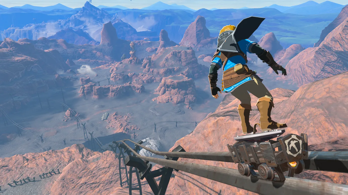 Link shield surfing down a slope in Tears of the Kingdom, kicking up a trail of dust behind him.