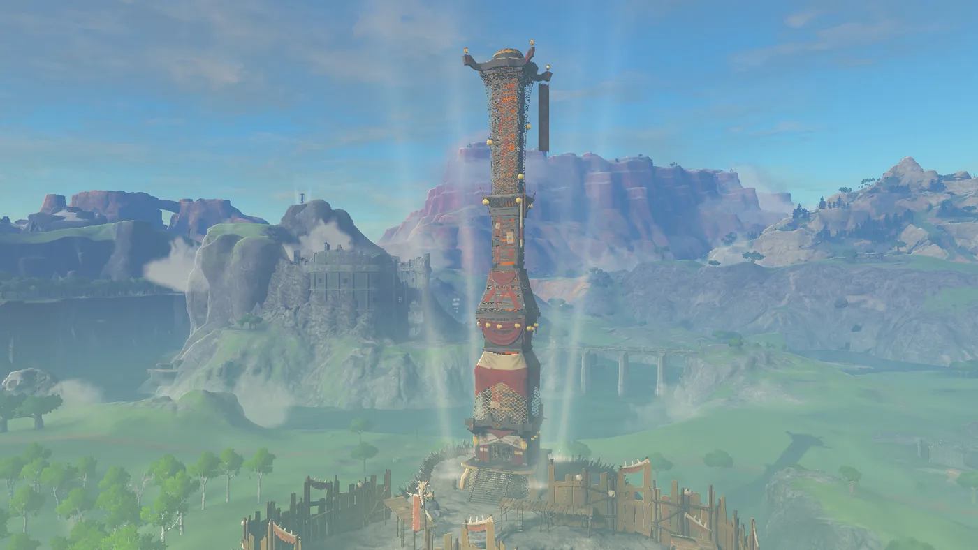 The Hyrule Field Skyview Tower on a hilltop ringed by a wooden spiked palisade and monster-camp banners, four light beams rising around it, with green Hyrule Field, a stone bridge and red-rock cliffs stretching behind.