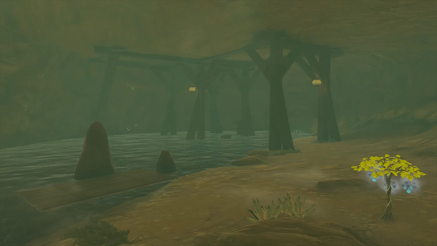 Inside Meadela's Mantle Cave: a dark underground river running under a row of thick wooden support beams hung with two lanterns, a wooden board at the near bank, and a small yellow-leafed plant with glowing blue fruit on the sandy shore.